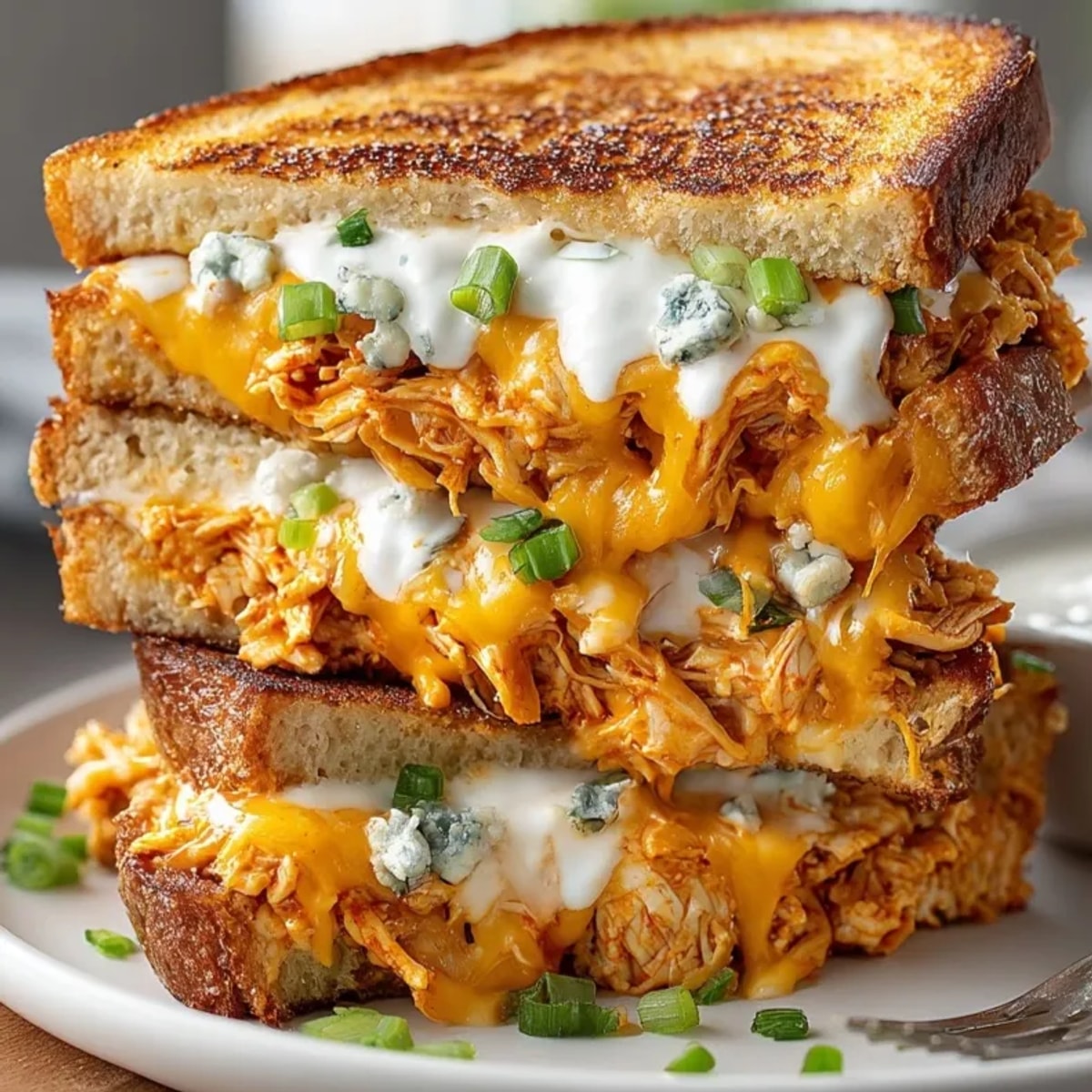Crispy Buffalo Chicken Grilled Cheese, a spicy, savory sandwich ready to be dipped in ranch.