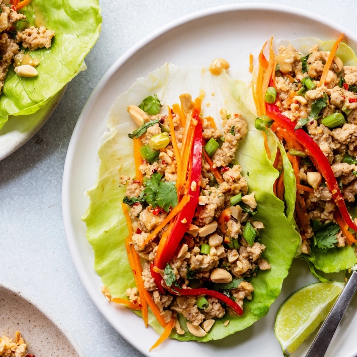 Homemade Thai Peanut Turkey Lettuce Wraps with fresh cilantro and crumbled peanuts.