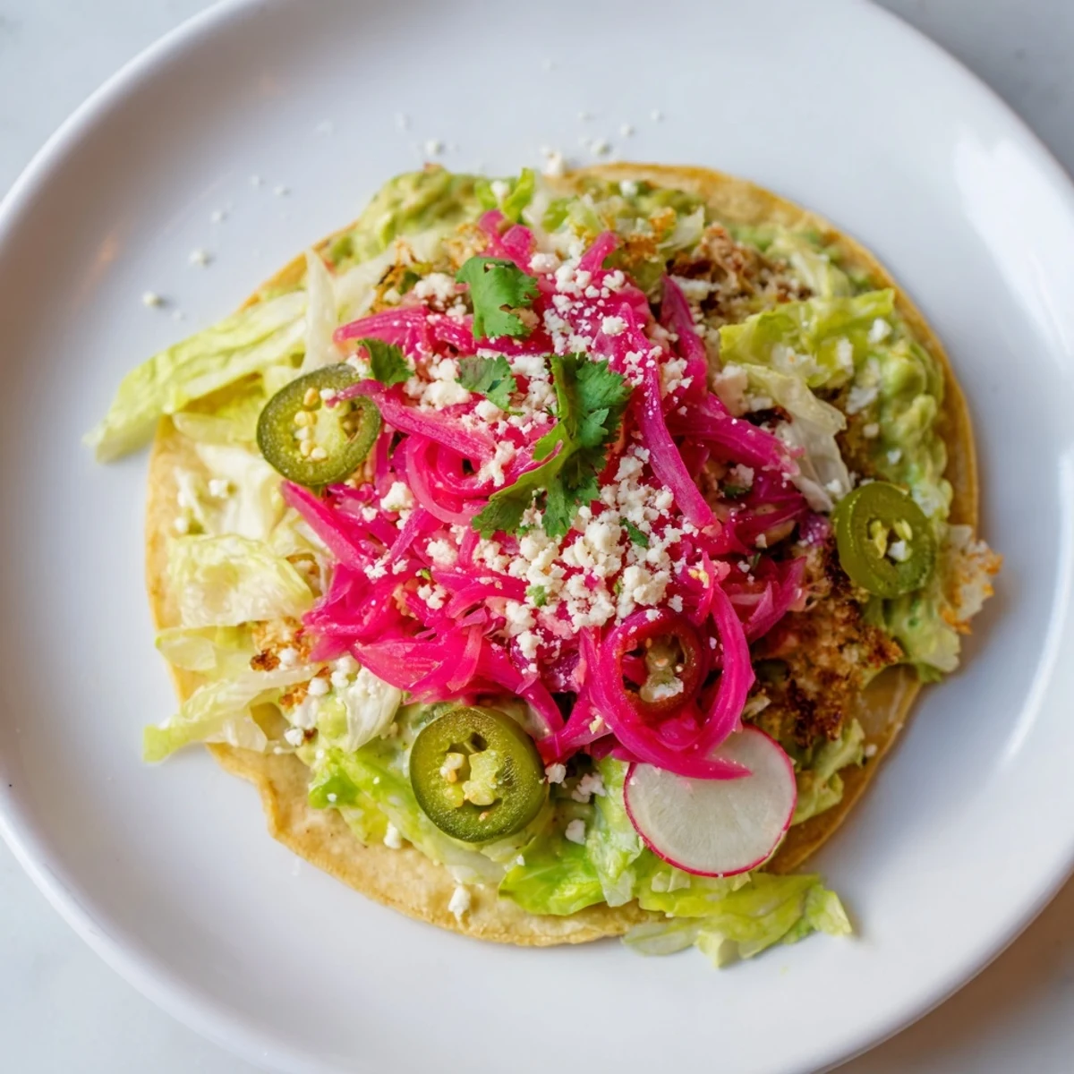Fresh, flavorful 5-minute pickled red onion tacos, featuring creamy avocado crema and crunchy toppings.