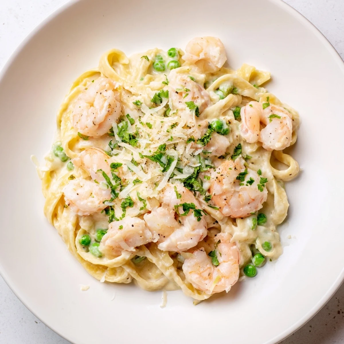 Up-close view of rich Instant Pot Shrimp Alfredo Pasta, garnished with fresh parsley, ready to eat!