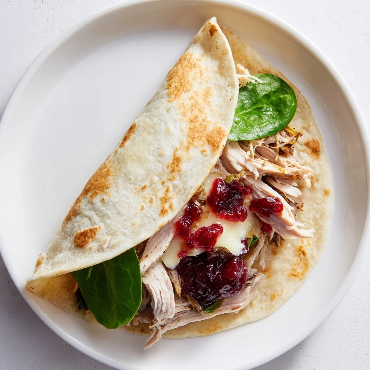 A close-up view of a delicious Moist Maker Chicken Wrap, ready to eat, with crispy edges and visible stuffing.