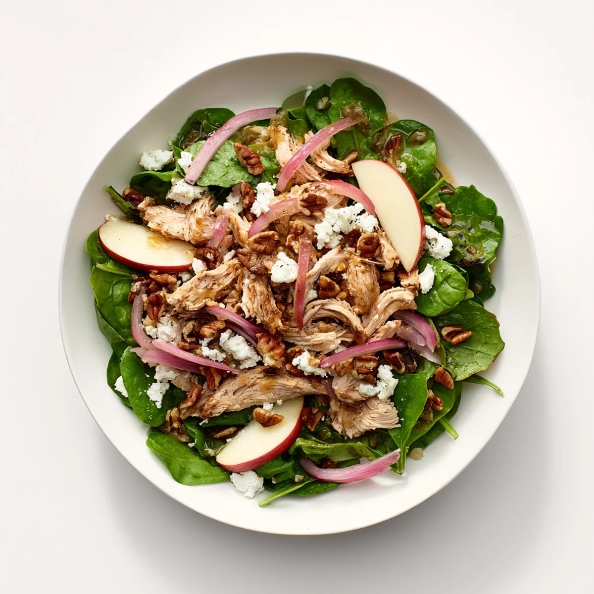 Enjoy a close-up of this Chicken and Apple Winter Salad – a perfect, hearty dish with crunchy pecans.