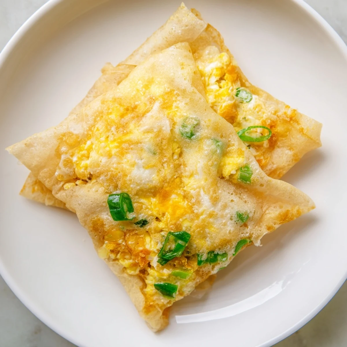 Golden, crispy Rice Paper Egg & Cheese Fold, a quick & easy breakfast snack with melted cheese.