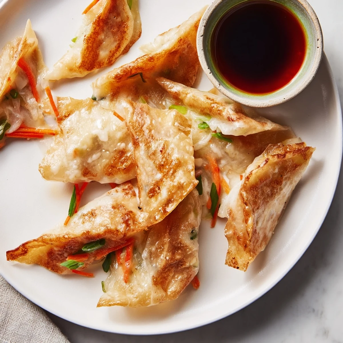 Freshly assembled crispy rice paper dumplings, served with a vibrant dipping sauce, ready to eat.