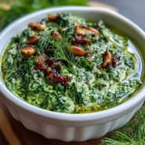 Bright dandelion pesto with garlic and pine nuts, perfect for pasta or sandwiches.  