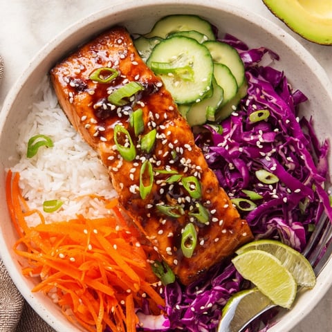 Tasty Soy-Maple Salmon Rice Bowls: Flaky salmon over rice with fresh veggies.