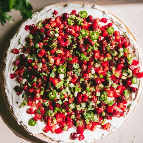 Vibrant Spiced Cranberry Jalapeño Cream Cheese Dip with a sweet-and-spicy cranberry topping.