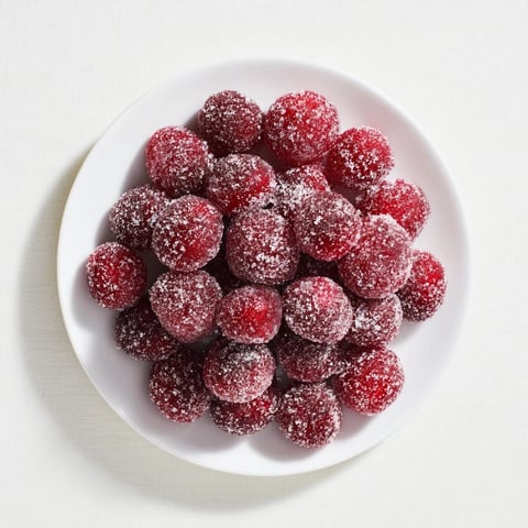 Vibrant 5-Minute Express Candied Cranberries, glistening with sugar, are perfect for festive desserts.