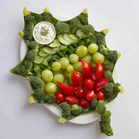 Fresh and vibrant Holly Leaf Veggie Board, colorful vegetables arranged for a festive holiday appetizer.