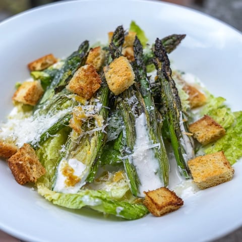 Vibrant Roasted Asparagus Caesar Salad with charred asparagus, crispy croutons, and creamy yogurt dressing.