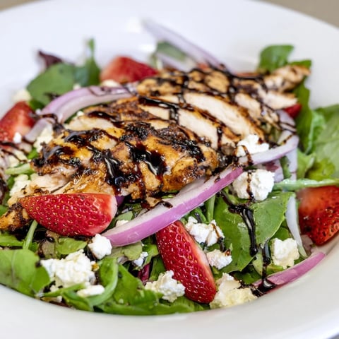 Close-up of a refreshing Strawberry Balsamic Chicken Salad, with grilled chicken and sweet strawberries.