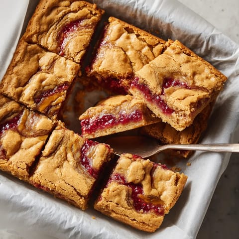 A slice of cake with jelly on it.