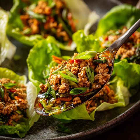 A spoon full of meat and vegetables.