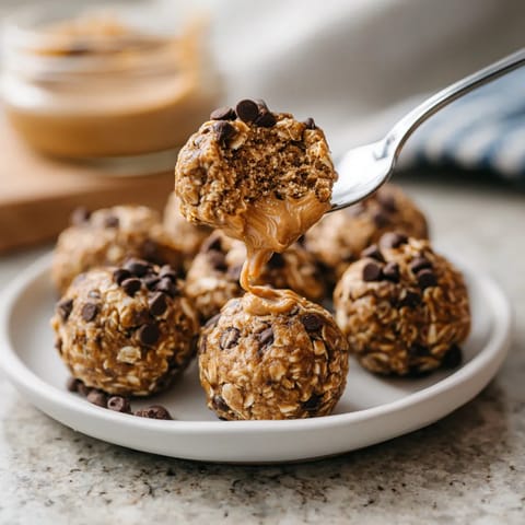 A plate of chocolate covered peanut butter balls.