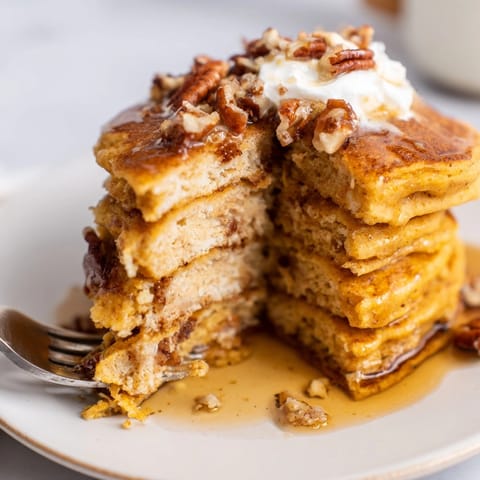 Golden Pumpkin Ricotta Pancakes cooking on a griddle, smelling of cinnamon and nutmeg.