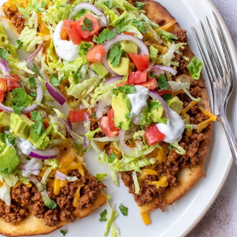 Stacked spicy turkey taco flatbreads topped with colorful fresh veggies, a Tex-Mex delight.