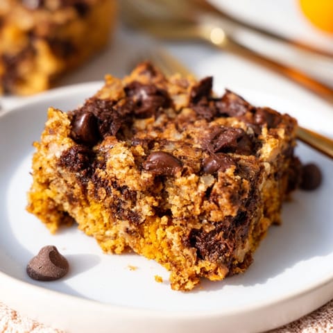 Warm, spiced Chocolate Pumpkin Chip Blondies, a cozy fall dessert served in squares.