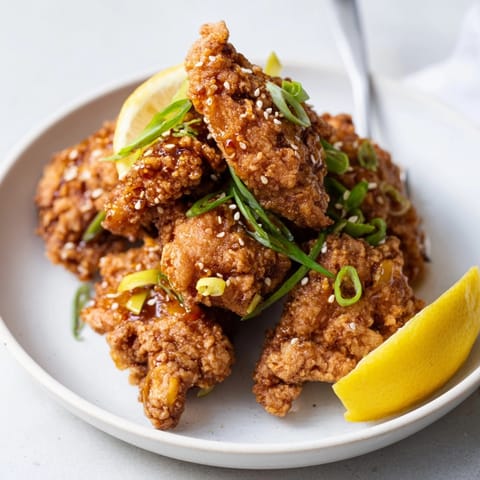 Close-up of Karaage Japanese fried chicken, sweet chili glaze, sesame seeds, ready to eat.