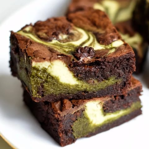 Golden Matcha Cheesecake Swirl Brownies fresh from the oven, ready to be sliced.