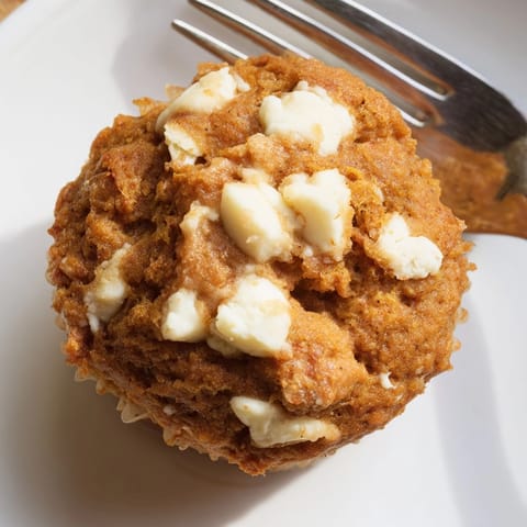 Freshly baked Pumpkin Muffins with White Chocolate visible; a perfect fall treat on display.
