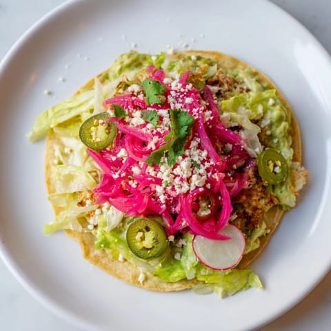 Fresh, flavorful 5-minute pickled red onion tacos, featuring creamy avocado crema and crunchy toppings.