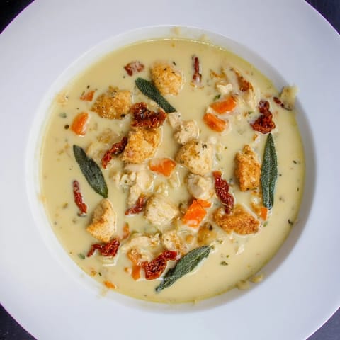 Savor the rich, flavorful Marry Me Chicken Soup, showcasing tender chicken pieces and vibrant vegetables.