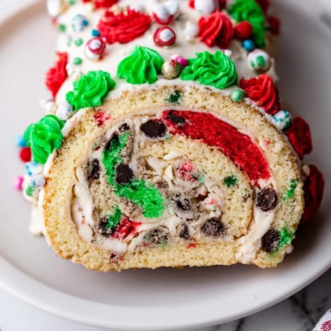 Festive Ugly Sweater Cake Roll with colorful frosting and holiday sprinkles, ready to serve.