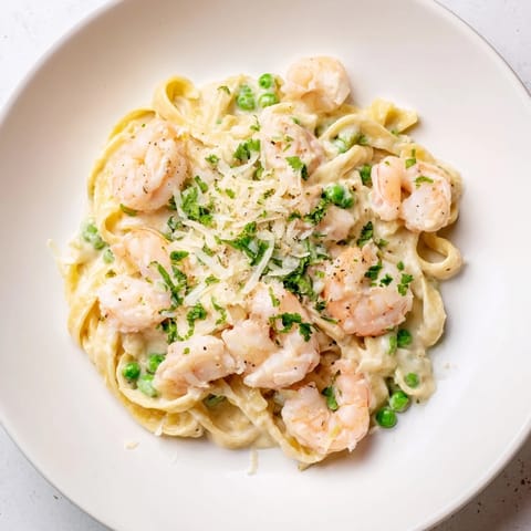 Up-close view of rich Instant Pot Shrimp Alfredo Pasta, garnished with fresh parsley, ready to eat!