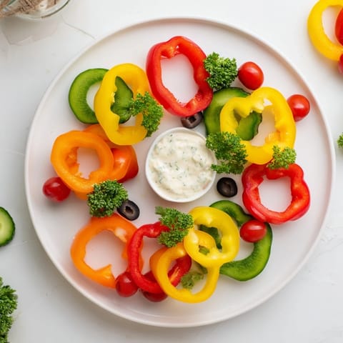 Fresh, crisp Festive Bell Pepper Wreath appetizer, beautifully arranged with a flavorful herb dip centerpiece.