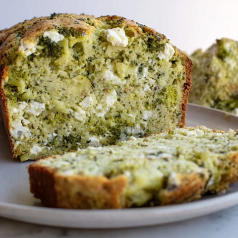 Moist and savory Mediterranean-style broccoli and feta loaf with creamy cheese, perfect for a nutritious snack or light lunch.  