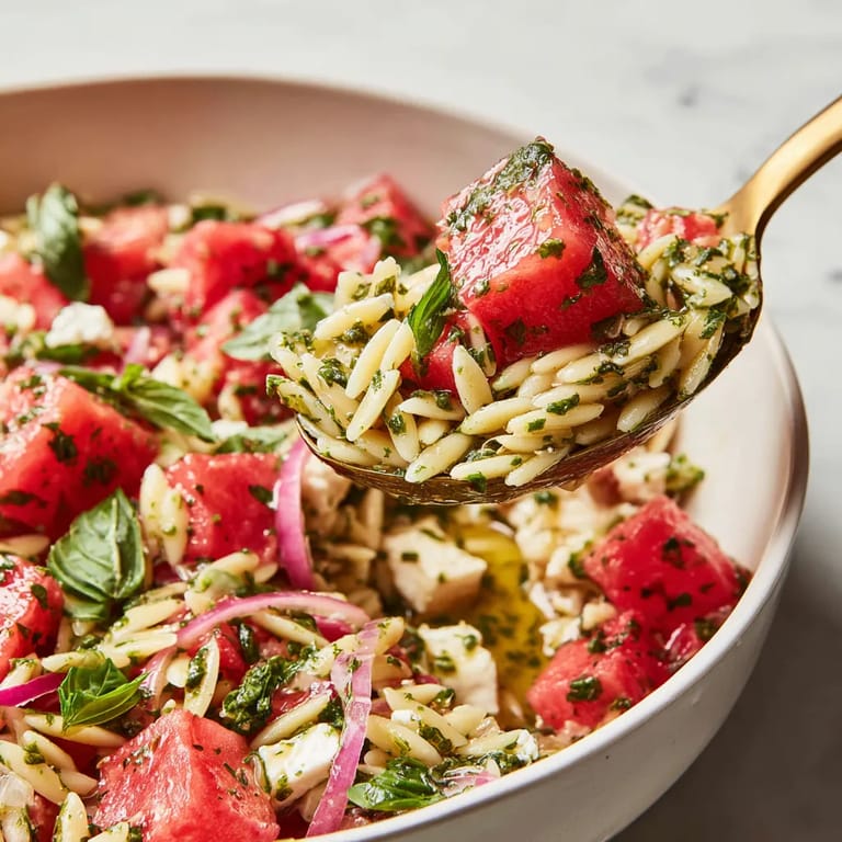 A spoon is scooping up a bowl of food.