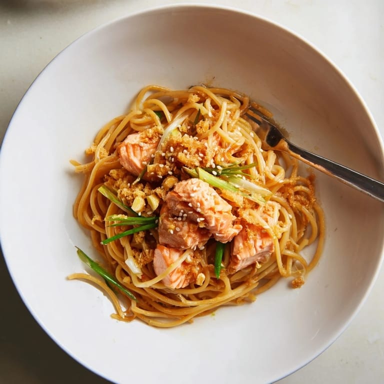 Crispy salmon fillets atop al dente spaghetti, drizzled with rich soy-mirin sauce.