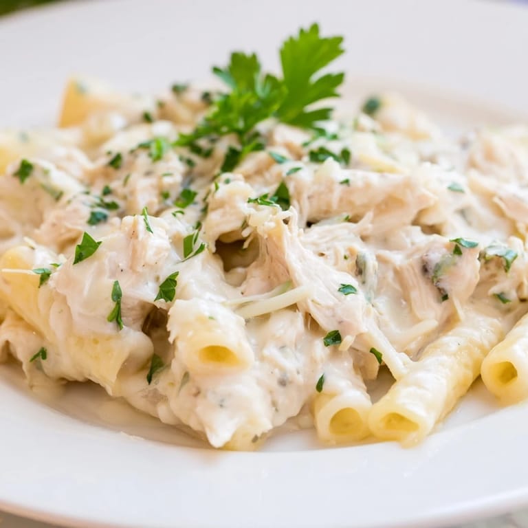 Tender chicken and penne pasta smothered in rich Alfredo sauce, a slow-cooker chicken Alfredo pasta bake.