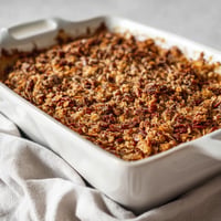 A white bowl with a casserole in it.